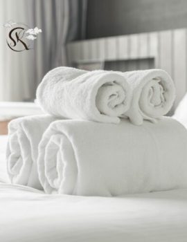 Luxury bed linen and window blinds in modern bedroom setup
